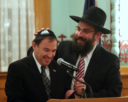 Rick Egan   |  The Salt Lake Tribune

 
Rabbi Benny Zippel, helps Gov. Gary Herbert put his Yarmulke back on, after it tumbled off during as he spoke at the Chanukah Ceremony at the Governors Mansion, Thursday, December 2, 2010