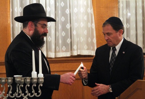 Rick Egan   |  The Salt Lake Tribune

 
Rabbi Benny Zippel, holds the candle as Gov. Gary Herbert lights it, during the Chanukah Ceremony at the Governors Mansion, Thursday, December 2, 2010