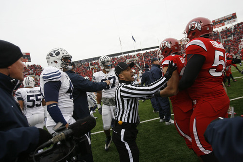 Chris Detrick  |  The Salt Lake Tribune

A referee breaks up a fight between Utah and BYU players before kick off as the Utes face BYU at Rice-Eccles Stadium Saturday, November 27, 2010.