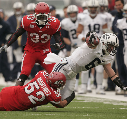 Trent Nelson  |  The Salt Lake Tribune

BYU receiver McKay Jacobson (6) is tackled by Utah Utes linebacker Matt Martinez (52) as the Utes face BYU in the first quarter at Rice-Eccles Stadium Saturday, November 27, 2010.
