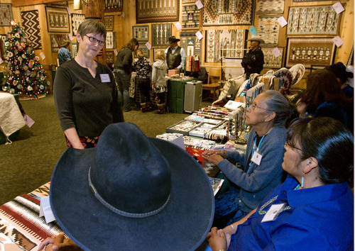 Steve Griffin  |  The Salt Lake Tribune

Mary Phillips talks with Navajo weavers during the 21st Annual Navajo Rug Show and Sale in the Snow Park Lodge at Deer Valley  in Park City Friday, November 12, 2010.  After her teenager daughter was killed by a drunk driver years ago, Phillips decided to find a way to give back during the holidays to other teenagers - who are often left out of mainstream christmas programs. Each year her family helps another family with teenagers during the holiday season. In her other life, she does development work for the Adopt-A-Native-Elder Program.