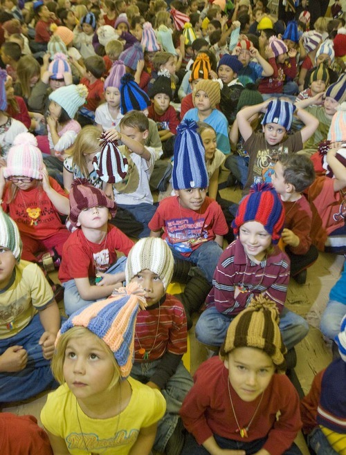 Paul Fraughton  |  The Salt Lake Tribune   Students at Oquirrh Hills  Elementary School in Kearns try on their new winter hats, made for them by prison inmate Robert  E. Jones on  Friday,December 3, 2010