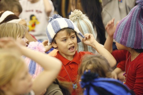Paul Fraughton  |  The Salt Lake Tribune   Students at Oquirrh Hills  Elementary School in Kearns try on their new winter hats, made for them by prison inmate Robert  E. Jones. Friday, December 3, 2010