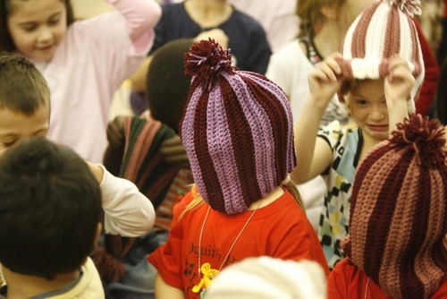 Paul Fraughton  |  The Salt Lake Tribune    An Oquirrh Hills Elementary student has some fun with his new winter hat, one of almost 600 made by prison inmate Robert E. Jones and distributed on Friday, December 3, 2010.