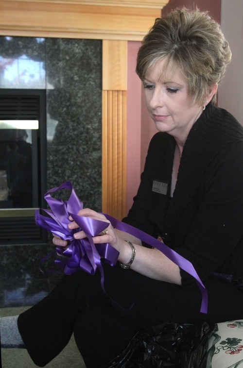 Rick Egan  | The Salt Lake Tribune
Colleen Russell, who lives just a few blocks from Steve Powell's home in Puyallup, Wash., holds a purple bow Nov. 3. Russell and her friends hung purple bows and missing-person fliers in the neighborhood last spring.