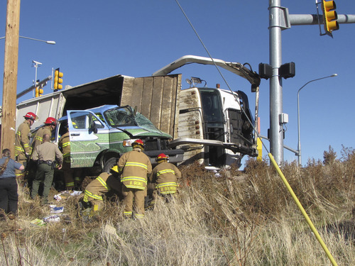 Mark Havnes | The Salt Lake Tribune
Cedar City firefighters on Monday work to free victims of a traffic accident from their van.