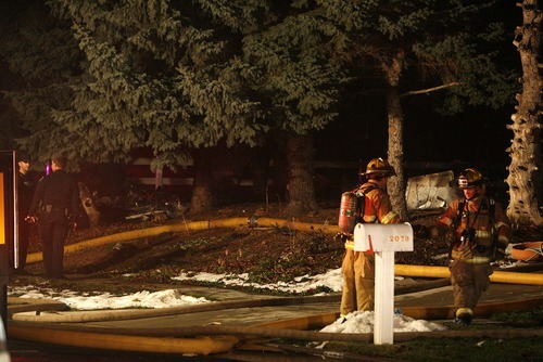 Trent Nelson  |  The Salt Lake Tribune

Firefighters work at the scene of a plane crash in Roy on Sunday, December 5, 2010. Wreckage of the plane appears to be on the lawn in the left and right of the frame.