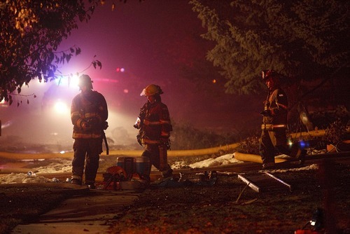 Trent Nelson  |  The Salt Lake Tribune
Firefighters at the scene of a plane crash Sunday, December 5, 2010 in Roy.