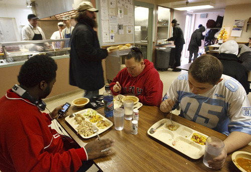 Leah Hogsten  |  The Salt Lake Tribune
l-r Michael, Cherry,  and Steven eat lunch every day at St. Anne's.  Michael lives at the shelter. St. Anne's Center for the homeless and low-income in Ogden is raising funds to build a new center on land at 3300 South and Pacific Ave. The plan is to be able to start construction next summer and finish by spring 2012. The current shelter at 137 West Binford (2650 South) is dilapidated and too small to meet the current needs, since the recession has flooded the shelter with more families.   Friday, December 3, 2010, in Ogden.