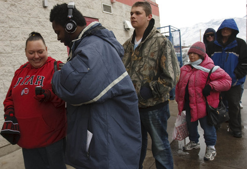 Leah Hogsten  |  The Salt Lake Tribune
l-r Cherry, Michael and Steven stand in line as they wait to enter St. Anne's for lunch. Michael lives at the shelter. 