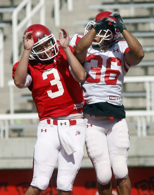 Steve Griffin  |  The Salt Lake Tribune

Utah quarterback Jordan Wynn, left, leaps into the air with running back Eddie Wide in the end zone after Wide scored a touchdown during the University of Utah football scrimmage at Rice Eccles Stadium inSalt Lake City on Thursday, August 12, 2010.