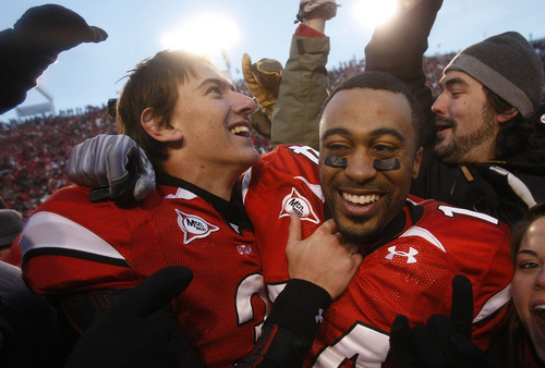 Chris Detrick  |  The Salt Lake Tribune

Utah Utes quarterback Jordan Wynn #3 and Utah Utes wide receiver Reggie Dunn #14 celebrate with fans after Utah beat BYU at Rice-Eccles Stadium Saturday, November 27, 2010.