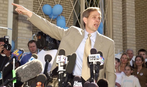 Trent Nelson  |  The Salt Lake Tribune

Ed Smart points into the mountains where his daughter Elizabeth apparently lived with her kidnapper. Ed Smart, Elizabeth's father, spoke with reporters in front of the Federal Heights LDS Chapel the day after his daughter was found safe in March 2003.
