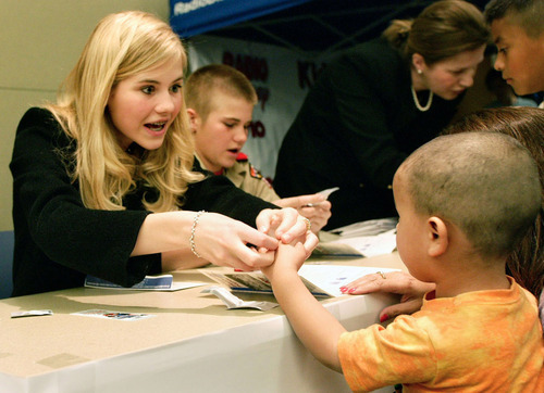 Danny Chan La  |  The Salt Lake Tribune 

Elizabeth Smart helps 3-year-old Julian Lovato get fingerprinted at an event held at the Salt Lake Police Department's Pioneer Precinct in Salt Lake City in March 2005.