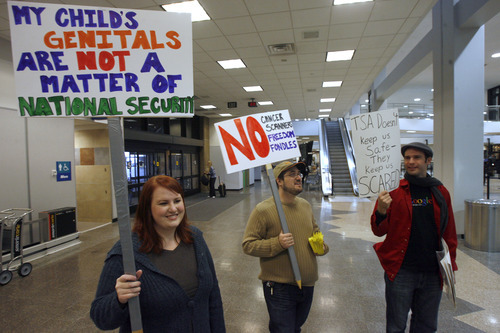 Rick Egan   |  The Salt Lake Tribune

L-R Shauna Harris, Jesse Harris and Julian Babbitt hold signs at  Salt Lake City International Airport, Saturday, December 11, 2010. A dozen protesters showed up to show their opposition to the TSA's new screening procedures.