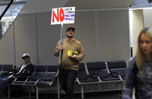 Rick Egan   |  The Salt Lake Tribune

Jesse Harris walks through the Salt Lake City International Airport with a protest sign Saturday, December 11, 2010. A dozen protesters showed up to show their opposition to the TSA and its new screening procedures.