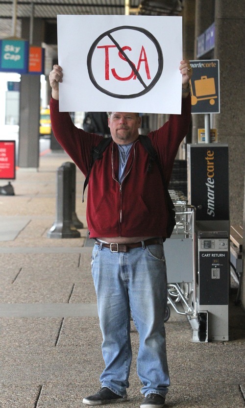 Rick Egan   |  The Salt Lake Tribune

Ralph (no last name given) holds a sign as he joins a handful of protesters at the Salt Lake City International Airport, Saturday, December 11, 2010