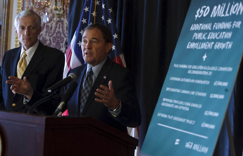 Leah Hogsten | The Salt Lake Tribune
Gov. Gary Herbert, flanked by Lt. Gov. Greg Bell, proposed an $11.9 billion state budget Friday. The spending blueprint would provide funds for new students entering public schools, try to alleviate pressure on the state prisons and keep many other programs essentially steady. Lawmakers, who begin meeting in January, will shape their own budget.