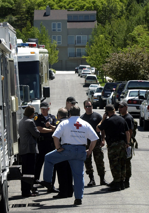 Steve Griffin  |  The Salt Lake Tribune

Salt Lake City authorities gather at the command center near the Salt Lake City home of 14-year-old Elizabeth Smart, who was kidnapped early June 5, 2002. The home is located near 1500 East and 300 North. The home that can be seen in the background is not the Smart home.