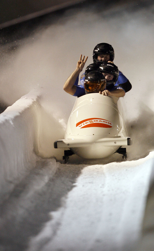 Francisco Kjolseth  |  The Salt Lake Tribune
The Canadian team of Lyndon Rush, Chris Le Bihan, Cody Sorensen and Neville Wright hold up the number three for their third place finish as athletes from around the world compete in the World Cup tour in the four man bobsled at Utah Olympic Park in Park City on Saturday, Dec. 11, 2010.