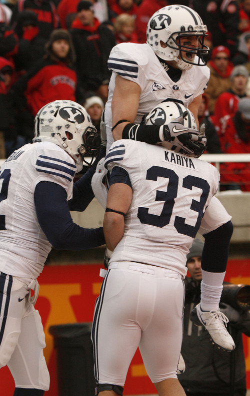 Trent Nelson  |  The Salt Lake Tribune

BYU receiver McKay Jacobson (6) celebrates his touchdown with BYU running back Bryan Kariya (33) and BYU running back Mike Hague (32) as the Utes face BYU in the third quarter at Rice-Eccles Stadium Saturday, November 27, 2010.