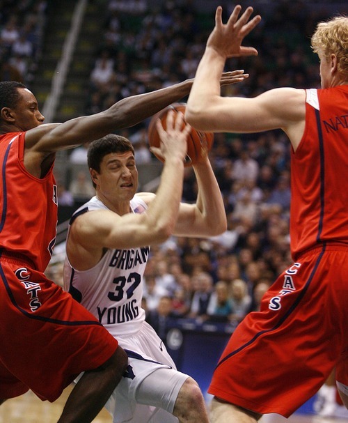 Djamila Grossman  |  The Salt Lake Tribune

Brigham Young University's Jimmer Fredette, 32, is blocked by the University of Arizona's Kyryl Natyazhko, 1, and Kyle Fogg, 21, during a game in Salt Lake City, on Saturday, Dec. 11, 2010. BYU won the game.