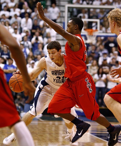 Djamila Grossman  |  The Salt Lake Tribune

Brigham Young University's Jimmer Fredette, 32, is blocked by the University of Arizona's Kyle Fogg, 21, during a game in Salt Lake City, on Saturday, Dec. 11, 2010. BYU won the game.