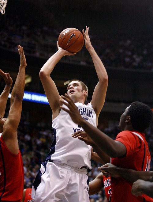Djamila Grossman  |  The Salt Lake Tribune

Brigham Young University's James Anderson, 15, scores as the University of Arizona's Solomon Hill, 44, watches on, during a game in Salt Lake City, on Saturday, Dec. 11, 2010. BYU won the game.