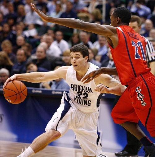 Djamila Grossman  |  The Salt Lake Tribune

Brigham Young University's Jimmer Fredette, 32, drives the ball to the basket as he is blocked by the University of Arizona's Kyle Fogg, 21, during the first half of a game in Salt Lake City, on Saturday, Dec. 11, 2010.