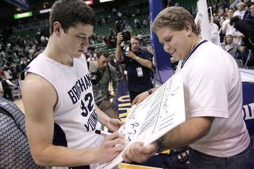 Djamila Grossman  |  The Salt Lake Tribune

Brigham Young University's Jimmer Fredette, 32, gives an autograph to fan Trent Boulter, after a game against the University of Arizona in Salt Lake City, on Saturday, Dec. 11, 2010. BYU won the game.