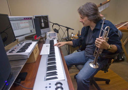 Al Hartmann  |  The Salt Lake Tribune 
Utah composer Kurt Bestor prepares for his 22nd annual Christmas concert series at his home studio.  He uses modern technology to compose his music and connect with his band members and audiences.  He often composes with one hand on a music keyboard and the other on a computer keyboard.  He also plays other insturments like a trumpet, harmonica, flute and  percussion instruments to fill in the creative mix.