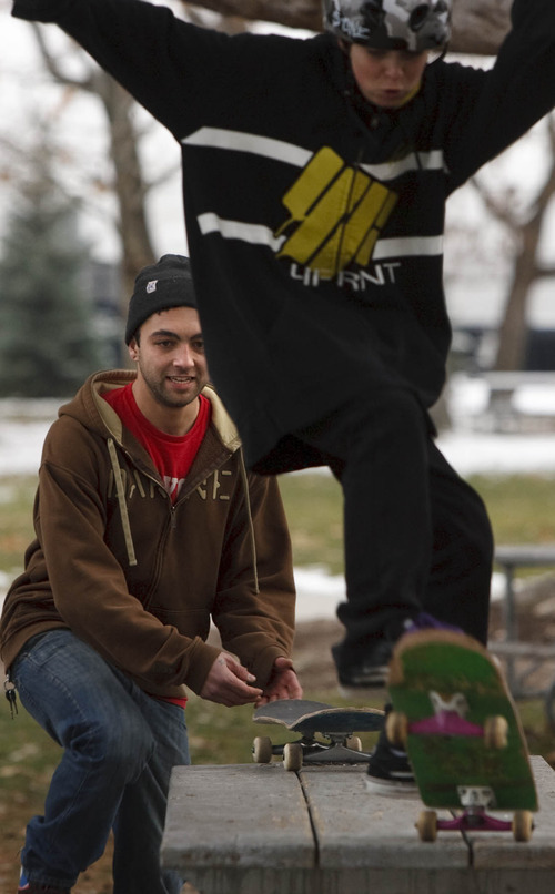 Leah Hogsten  |  The Salt Lake Tribune
 Skate 4 Homies director Tanner Montoya (left) watches as a student flies off of a picnic table in Liberty Park, Friday, December 17, 2010, in SLC.
Skate 4 Homies is an organization dedicated to the preservation of skateboarding. The Skate 4 Homies skateboarding classes involve skateboarding etiquette and skills, art and culture, and skateboarding history and the organization just concluded  a nine-week session of volunteer teaching for the kids of Youth City. The kids the created their own art decks that will be on display during an art show Saturday, December 18, 2010 at The Gateway.