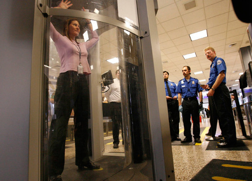 LEAH HOGSTEN | Tribune File Photo

Transportation Security Administration instructor Sherrie Soto (in pink) from Washington, D.C., stands in the Millimeter Wave Detection unit as Salt Lake International Airport TSA security officers learn earlier this year how to instruct airline passengers through the airport's newest screening process.