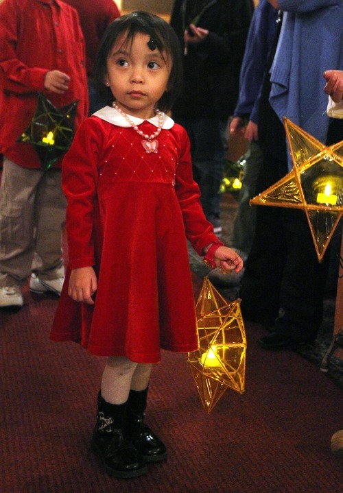 Rick Egan   |  The Salt Lake Tribune

3-year-old Nicole Mendoza holds a hand-made lantern before mass at Our lady of Lourdes,  Wednesday, Dec. 15, 2010.