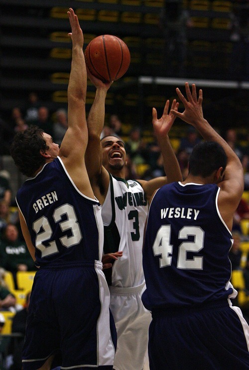 Djamila Grossman  |  The Salt Lake Tribune

Utah Valley University's Shawn Deadwiler, 3, along with Utah State University's Tai Wesley, 42, and Brian Green, 23, try to grab the ball during a game at UVU, Saturday, Dec. 18, 2010. USU won the game.