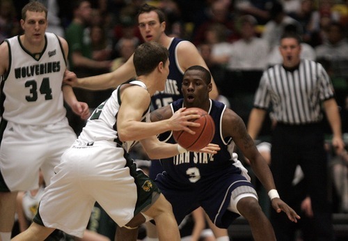 Djamila Grossman  |  The Salt Lake Tribune

Utah State University's Brockeith Pane, 3, guards Utah Valley University's Holton Hunsaker, 12, who drives the ball to the basket during the first half of a game at UVU, Saturday, Dec. 18, 2010.