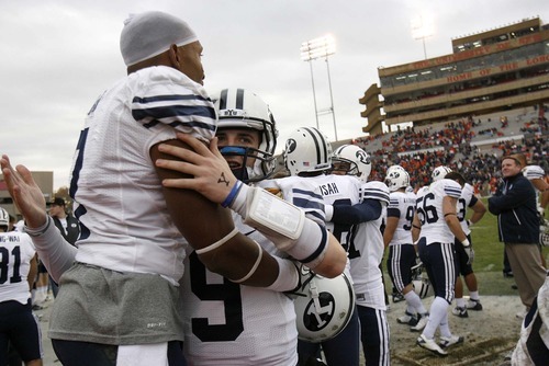 Trent Nelson  |  The Salt Lake Tribune
BYU quarterback Jake Heaps (9) embraces BYU defensive back Brian Logan (7) in the final minutes as BYU defeats UTEP in the New Mexico Bowl, college football Saturday, December 18, 2010 in Albuquerque, New Mexico.