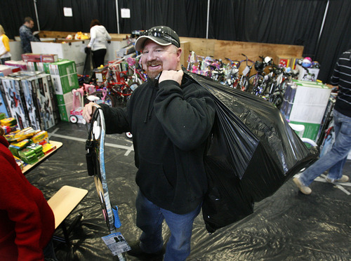 Scott Sommerdorf  l  The Salt Lake Tribune
Looking like Santa Claus himself, Kelly Luddington helps collect toys for a deserving family as a volunteer for Toys for Tots, the annual gift donation program run by the Marines. The  gifts were  distributed to families at Fort Douglas.