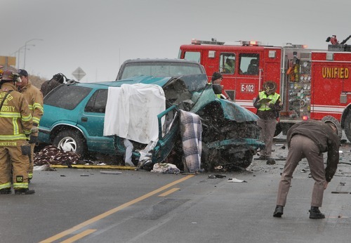 Rick Egan   |  The Salt Lake Tribune

Police and firefighters from Unified Fire, investigate a four car accident on highway 201 in Magna, Monday, December 20, 2010