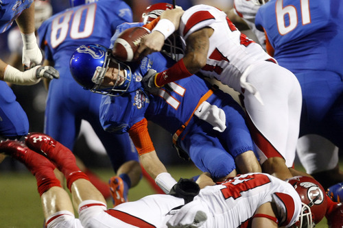 Chris Detrick  |  The Salt Lake Tribune 
Utah Utes cornerback Lamar Chapman #21 sacks Boise State Broncos quarterback Kellen Moore #11 during the first half of the Maaco Bowl at Sam Boyd Stadium Wednesday December 22, 2010.   Boise State is winning the game 16-3.