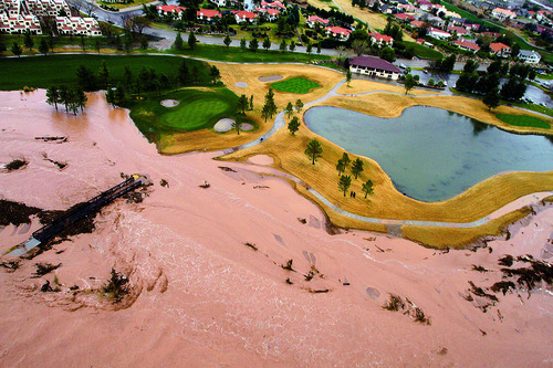 Flood waters flow down the middle of a golf course in St George, Utah on Tuesday, Dec. 21, 2010. (AP Photo/The Salt Lake Tribune, Rick Egan)