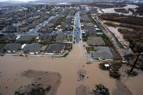 Rick Egan   |  The Salt Lake Tribune
Floodwaters inundate a neighborhood in St. George Dec. 21, 2010.