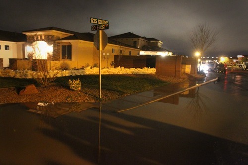 Rick Egan   |  The Salt Lake Tribune

Water surrounds the Kemp residence, in Stonegate subdivision, in Washington, Utah, Tuesday, December 21, 2010. Crews from Washington City were still pumping the water out of the streets late Tuesday night.