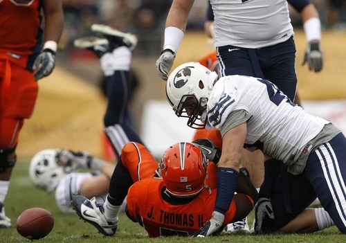 Trent Nelson  |  The Salt Lake Tribune
BYU linebacker Jadon Wagner (49) brings down UTEP's James Thomas II in the first half as BYU faces UTEP in the New Mexico Bowl, college football Saturday, December 18, 2010 in Albuquerque, New Mexico.