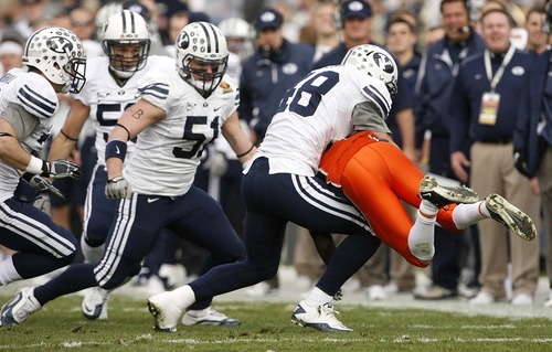 Trent Nelson  |  The Salt Lake Tribune
BYU linebacker Jameson Frazier (48) picks up UTEP's Marlon McClure and throws him to the ground in the first half as BYU faces UTEP in the New Mexico Bowl, college football Saturday, December 18, 2010 in Albuquerque, New Mexico.