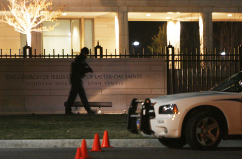 Francisco Kjolseth  |  The Salt Lake Tribune
South Jordan police officers use flashlights to look for evidence in their continued investigation of the scene of a fatal shooting at the LDS Oquirrh Mountain Temple in South Jordan on Saturday. Police shot and killed a suspect that appeared on scene with a shotgun.