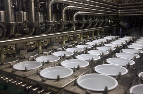 Steve Griffin  |  The Salt Lake Tribune
 
Yogurt cups are filled by a machine at the Dannon yogurt plant in West Jordan Monday, Dec. 6. The plant operates around the clock producing several kinds of yogurt.
