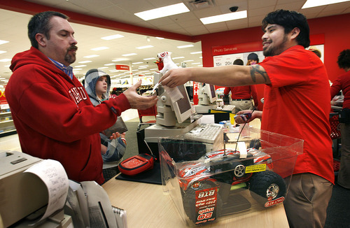 Scott Sommerdorf  l  The Salt Lake Tribune
Target customer service associate Armando Mata (right), cheerfully completes a return of a remote control RC car toy by Milt Stewart (left), Sunday, Dec. 26, 2010, the annual 