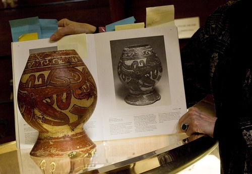 Djamila Grossman  |  The Salt Lake Tribune

Marsha Vargas Handley holds a catalogue with an identical photo next to a piece of pottery from Costa Rica, at her Xanadu Gallery in San Francisco, Saturday, Dec. 4, 2010. Being able to track a piece's past is one way to verify its authenticity.