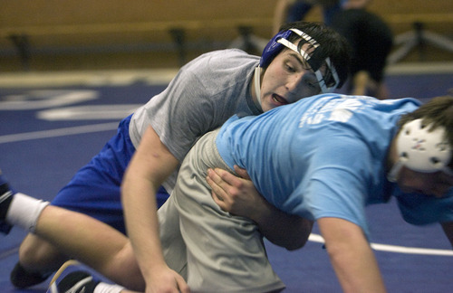 Al Hartmann  |  The Salt Lake Tribune 
Pleasant Grove wrestling standout Dustin Dennison in 215 lb class, left, works out with his younger brother Brandon in practice.